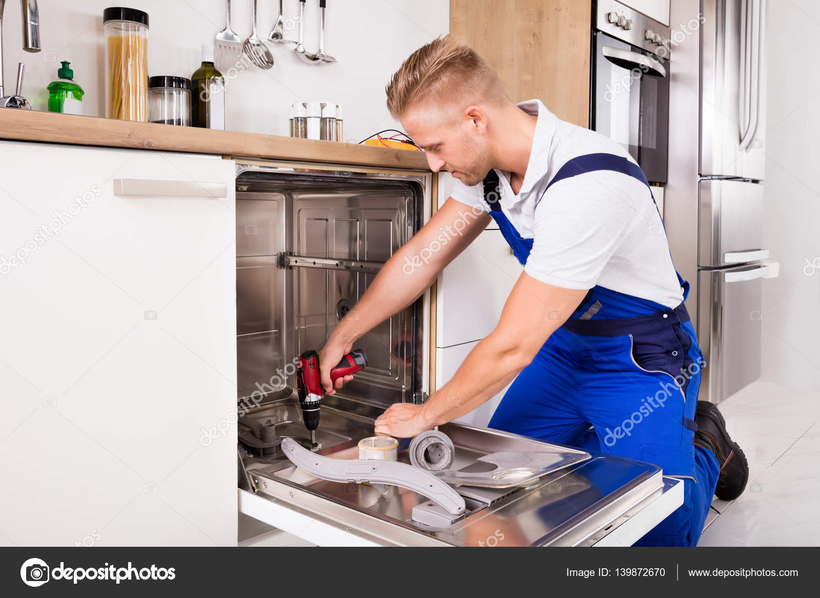 Repairman Fixing Dishwasher Stock Photo Repairman Fixing Dishwasher Stock Photo