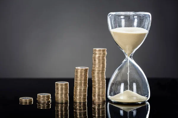 Hourglass Near Stack Of Coins — Stock Photo, Image