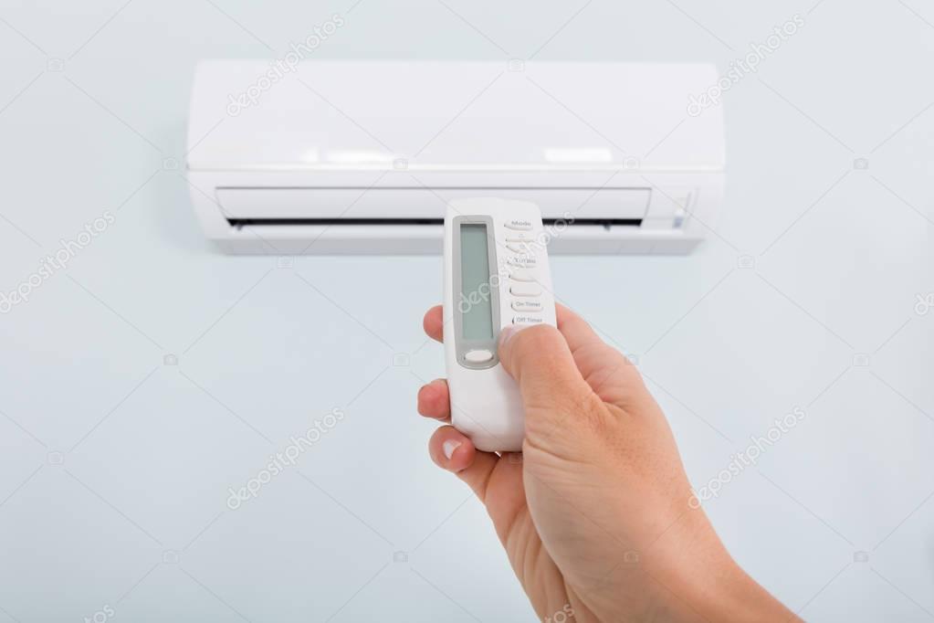 Person Operating Air Conditioner