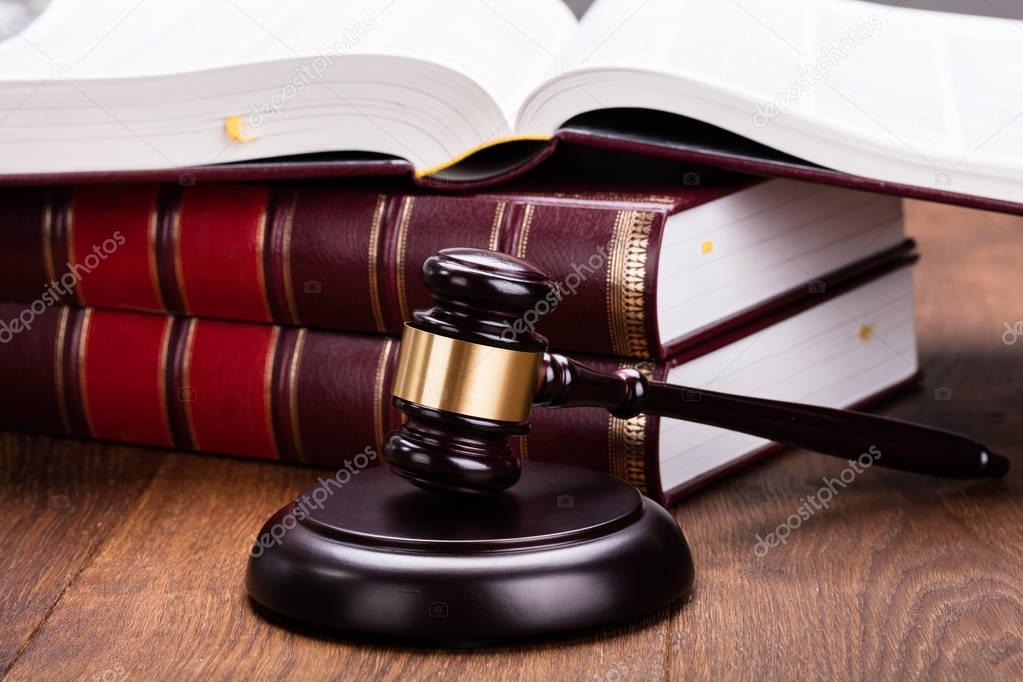 Gavel With Books On Wooden Desk