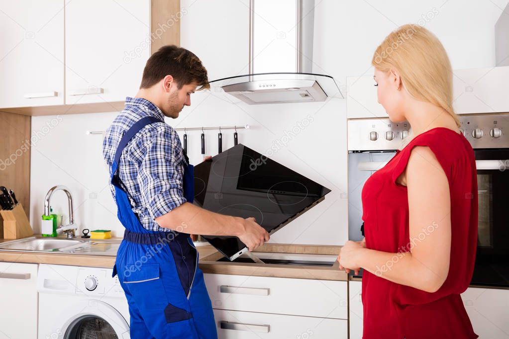 Repairman Examining Stove