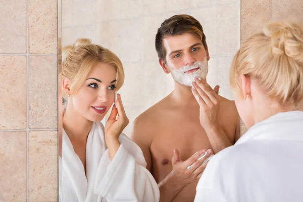 Man Shaving And Wife Cleaning Face