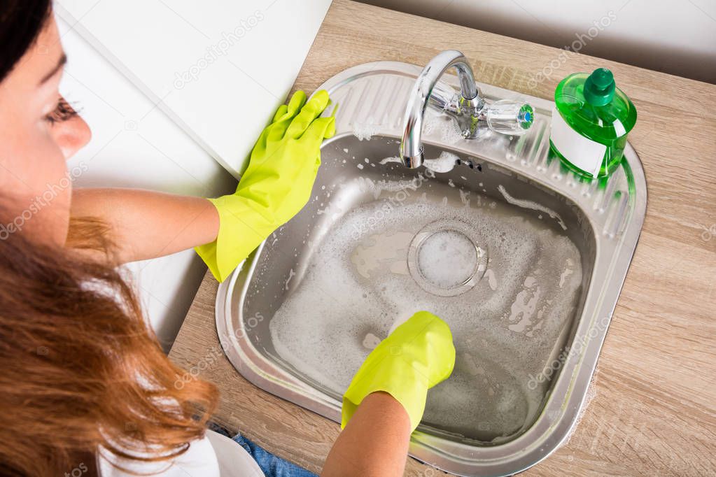 Woman Cleaning Sink