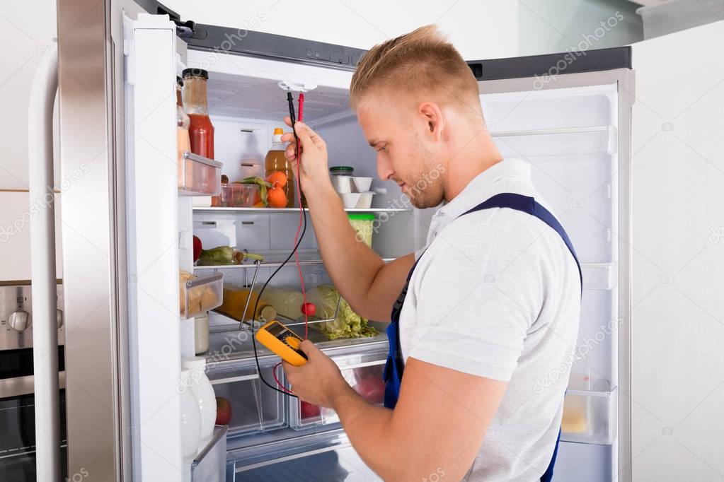 Repairman Checking Refrigerator