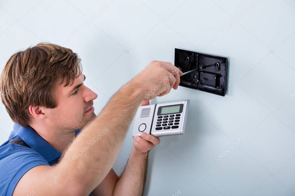 Technician Installing Security System