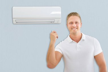 Man Using Air Conditioner clipart