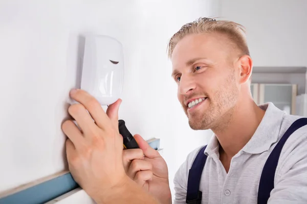 Elektriker installiert Bewegungsmelder — Stockfoto