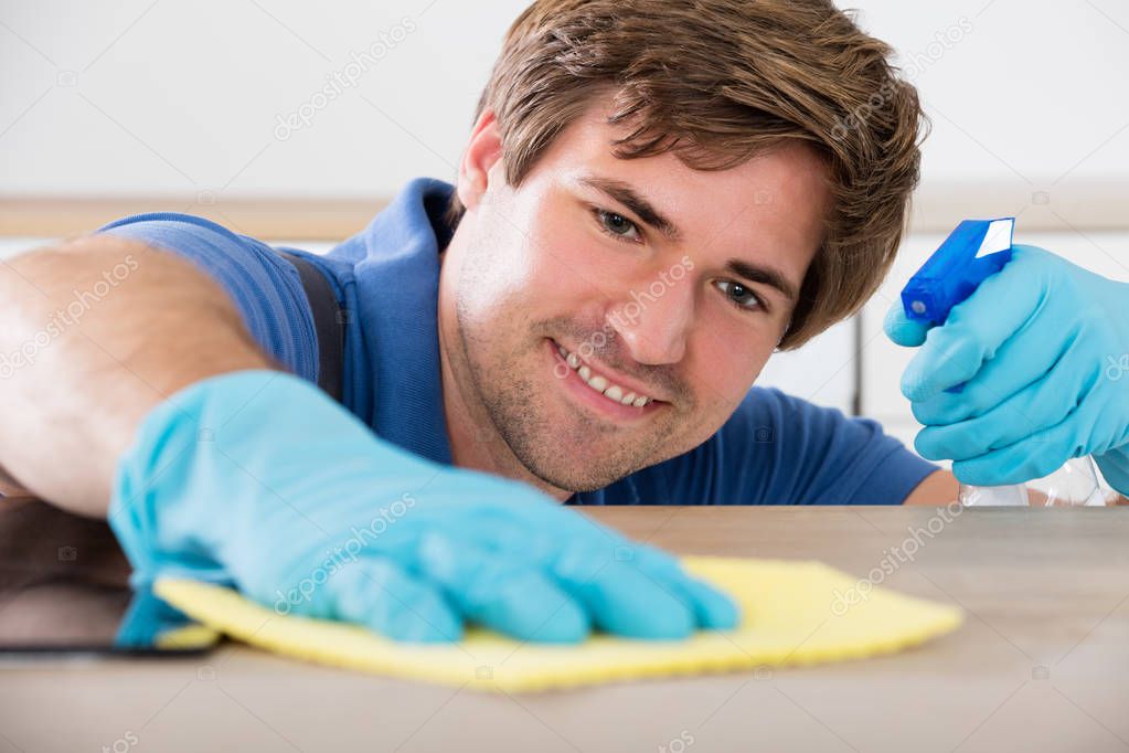 Worker Cleaning Countertop