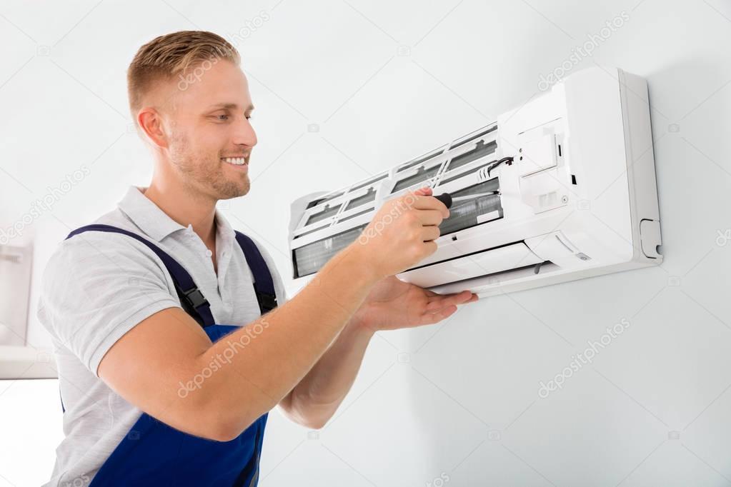 Technician Fixing Air Conditioner