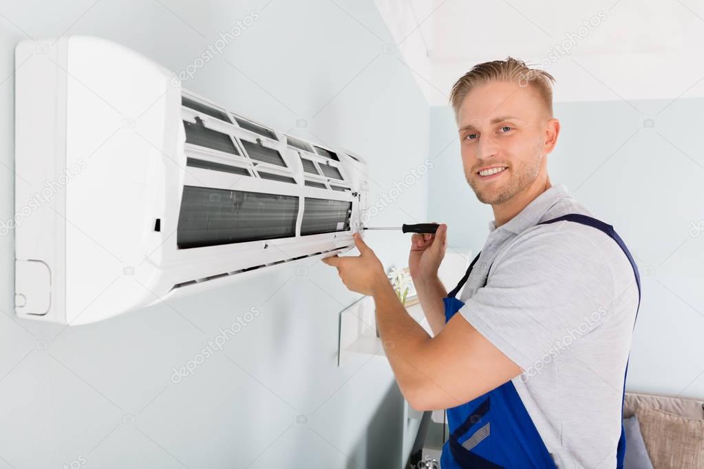 Technician Fixing Air Conditioner