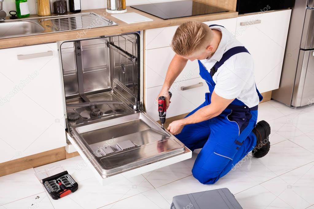 Repairman Fixing Dishwasher