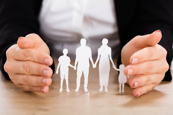 Family Papercut On Wooden Desk