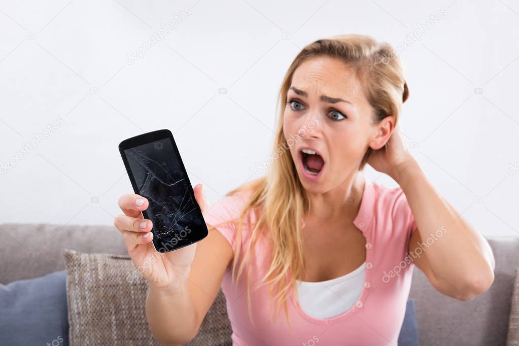 Woman Holding Damaged Mobilephone 