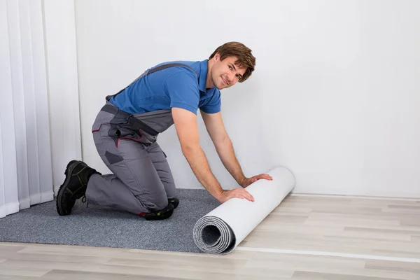 Handyman Rolling Carpet — Stock Photo, Image