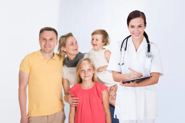 Doctor Writing Prescription Happy Family Standing Clinic Royalty Free Stock Images