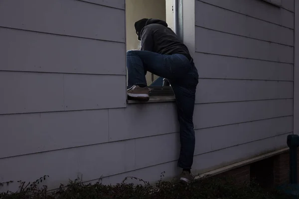 Burglar Entering House Through Window — Stock Photo, Image