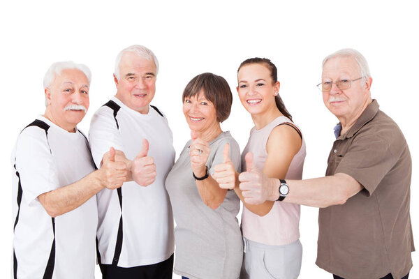 Group Of Senior People Showing Thumbs Up In Front Of White Background