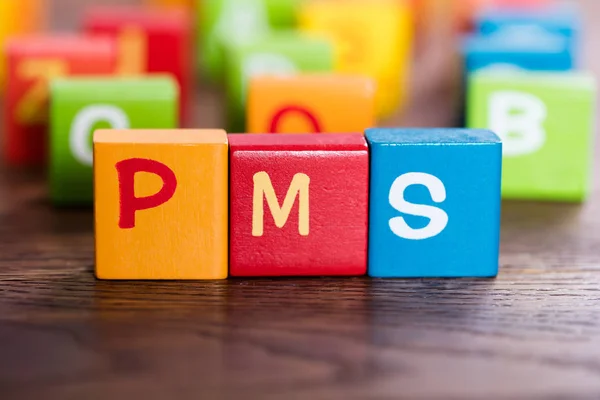 Palabra de PMS hecha con bloques — Foto de Stock