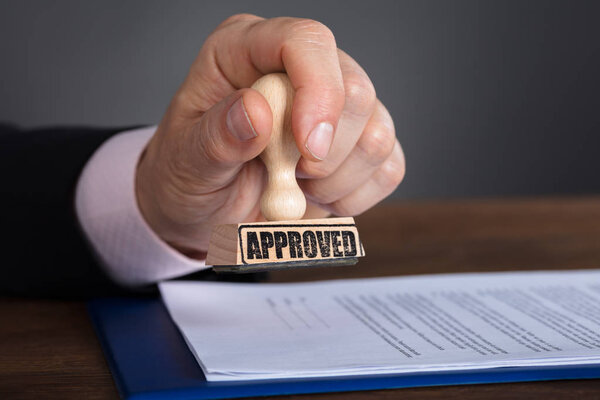 Person Stamping On Document