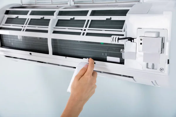 Close-up van vrouwelijke schoonmaken van de airconditioner — Stockfoto