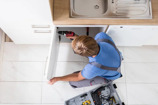 Man Repairing Cabinet — Stock Image Man Repairing Cabinet Stock Photo