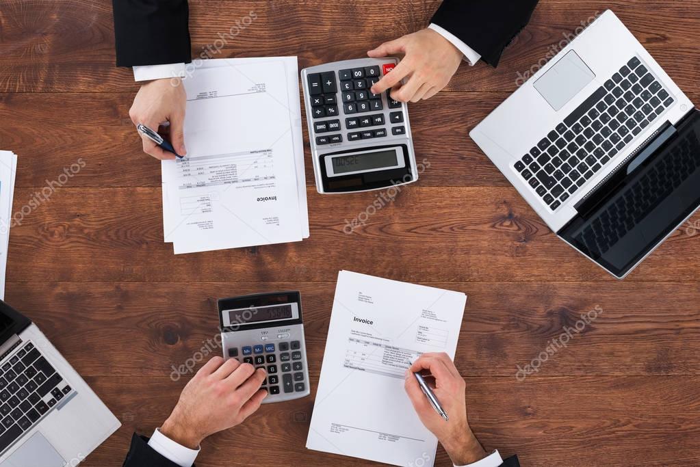 businesspeople calculating budget