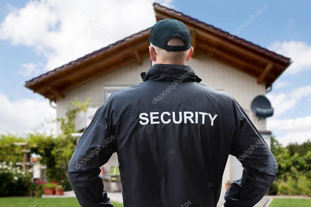 Guard Standing Outside House