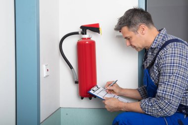 Professional Checking Fire Extinguisher clipart
