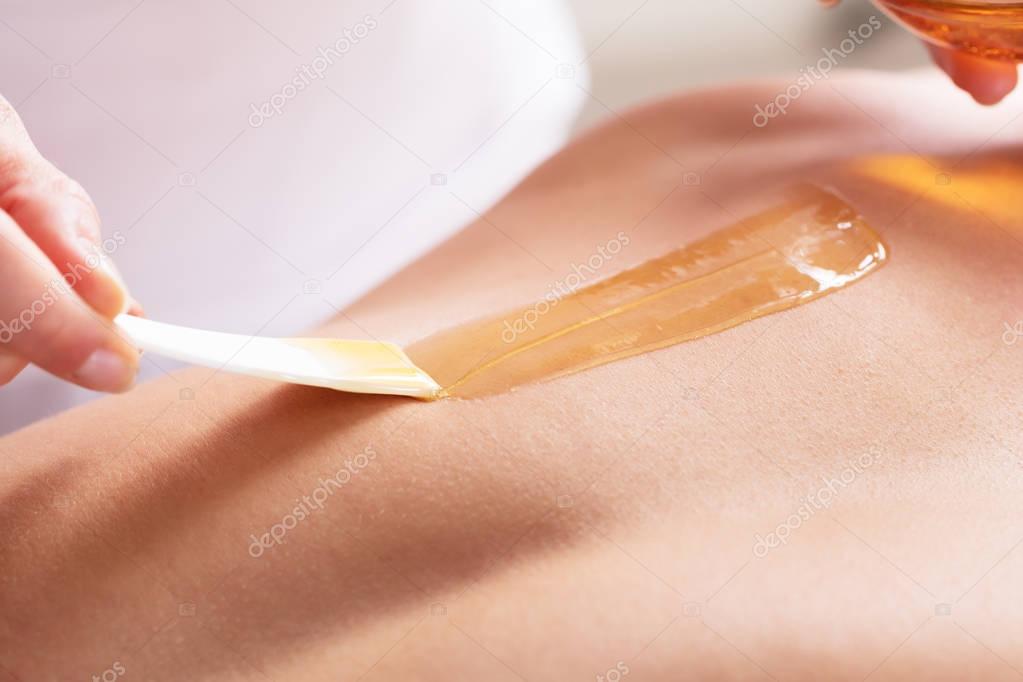 Woman Waxing Man Chest 