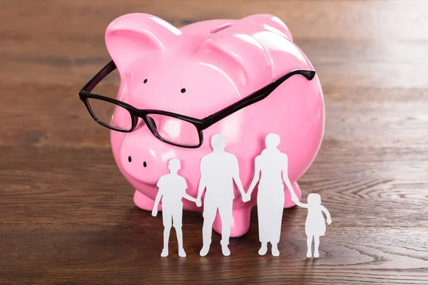 Piggybank と家族の紙のカット — ストック写真