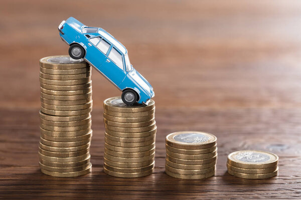 Car Model Over Stacked Coins