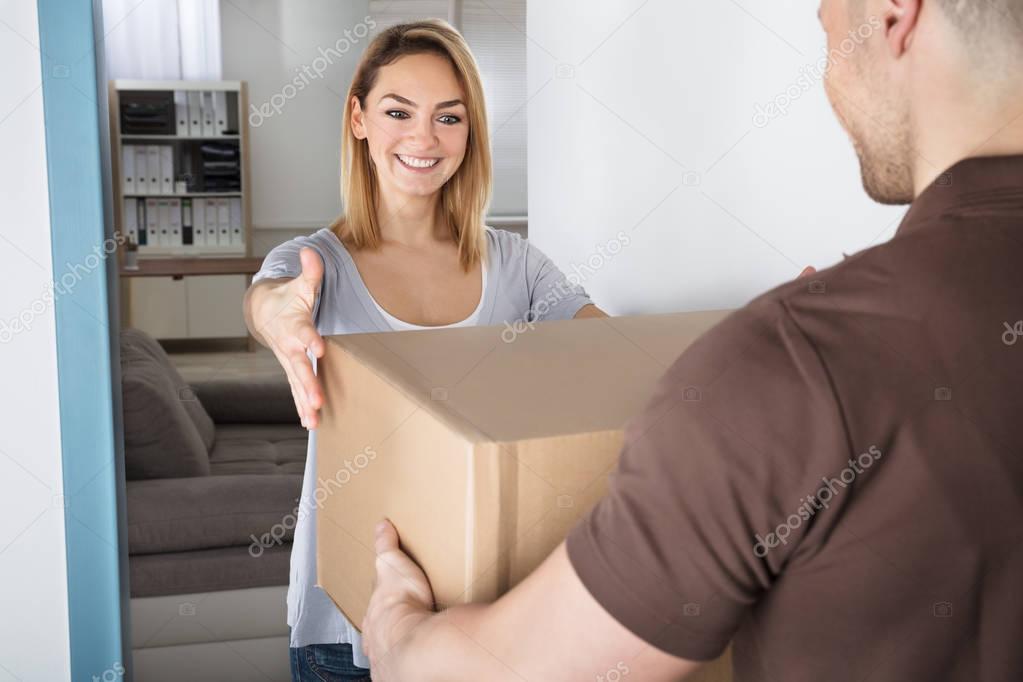 Woman Looking At Cardboard Box