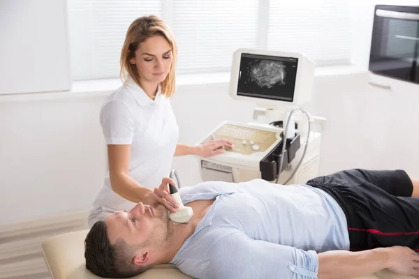 Doctor Performing Thyroid Ultrasound Tes — Stock Photo, Image