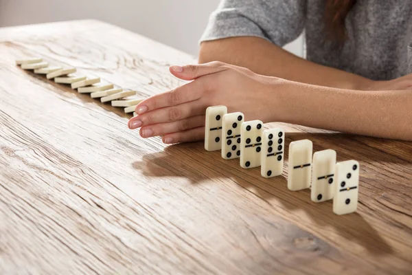 Businesswoman Supports Domino From Falling — Stock Photo, Image