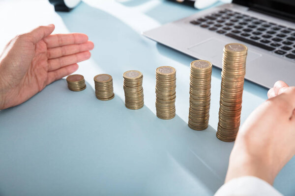 Person Protecting Coin Stacks