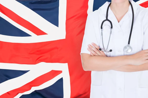 Doctor Standing Against British Flag — Stock Photo, Image