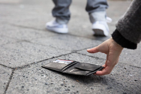 Person Picking Up Wallet