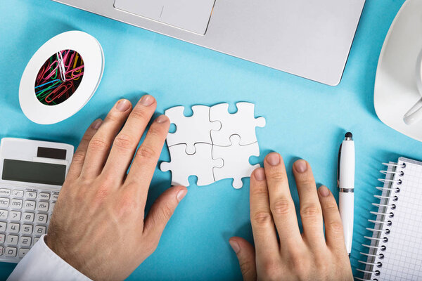 Businesperson Joining Puzzle
