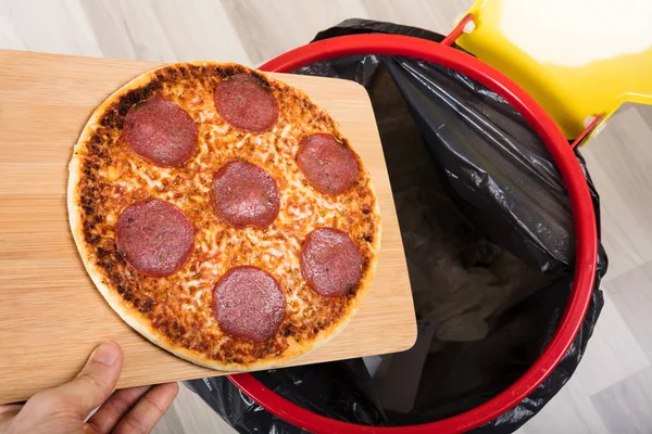 Person Throwing Salami Pizza — Stock Photo, Image