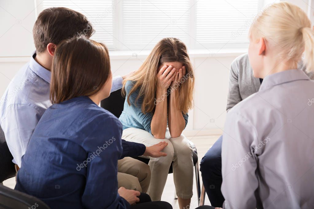 Group Of Friends Comforting Sad Mourning Woman