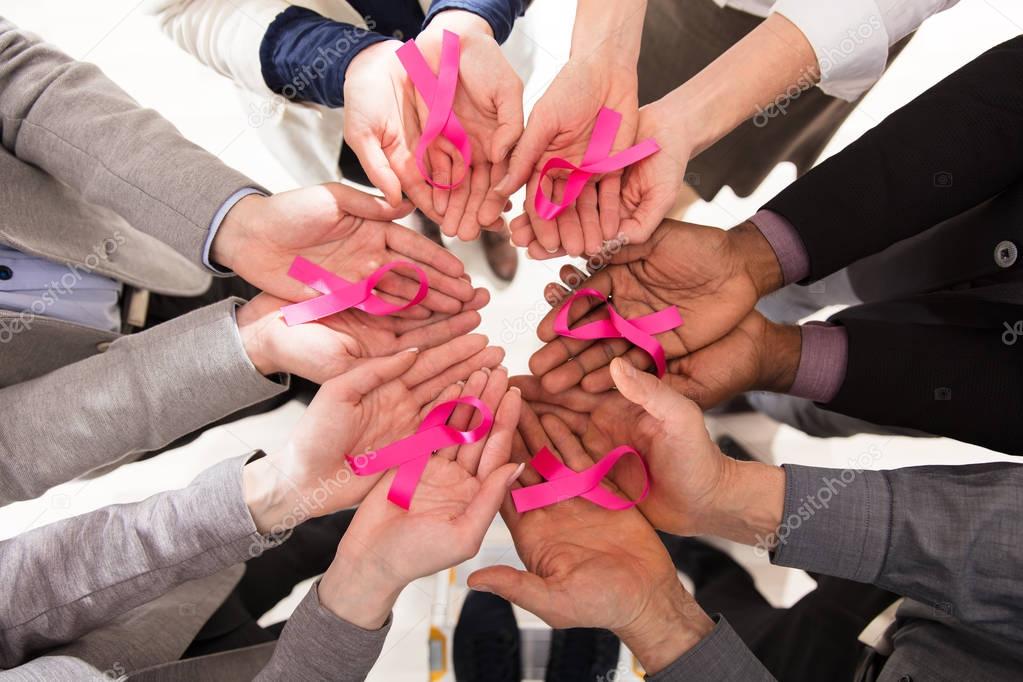 Businesspeople Showing Pink Ribbon 