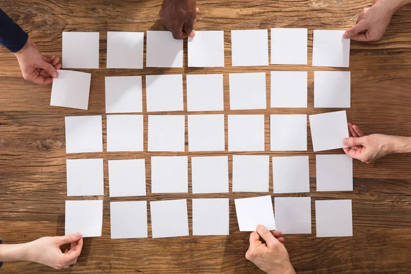 Overhead View People Hands Arranging White Papers Wooden Table — Stock Photo, Image