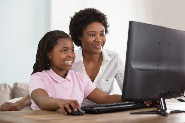 Мать и дочь за компьютером — стоковое фото