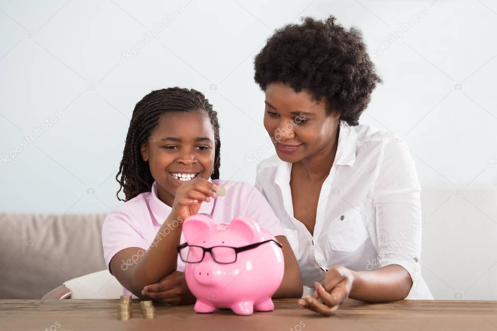 Girl With Mother Inserting Coins 