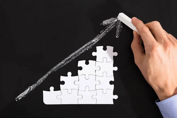 Person Arranging Puzzles On Blackboard — Stock Photo, Image