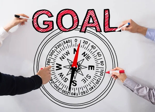Hands of people Drawing Goal Concept And Compass Diagram On White Background