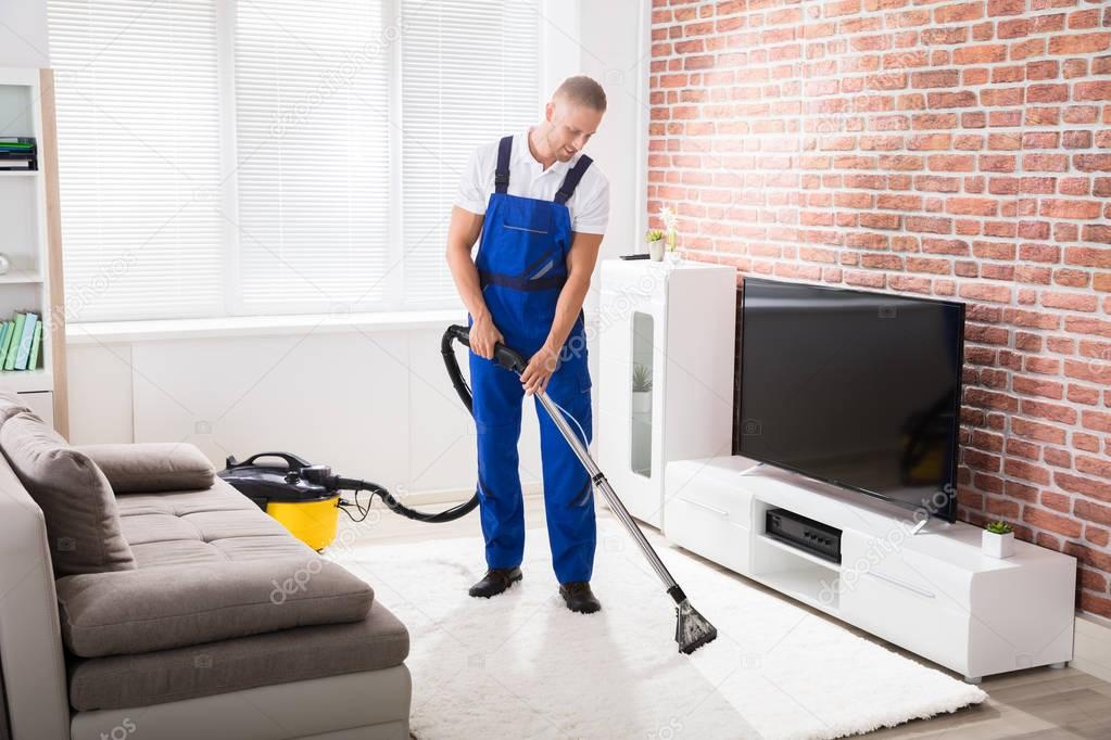 Male Janitor Vacuuming Carpet