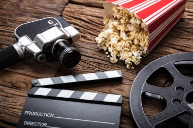 movie camera with clapper board and popcorn clipart