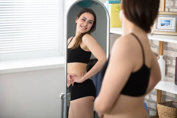 Mulher magro olhando no espelho — Fotografia de Stock