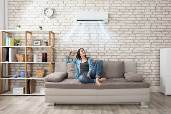 Woman Relaxing Under Air Conditioner